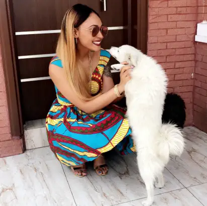 Rosaline Meurer with her Samoyed puppy standing up and leaning towards her