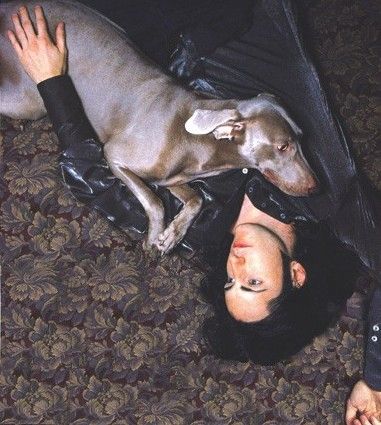 Trent Reznor lying on the floor with his Greyhound leaning on his chest