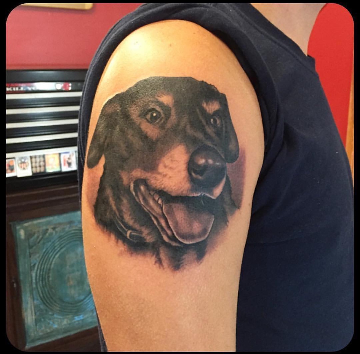 realistic face of a Labrador Retriever tattoo on the shoulder