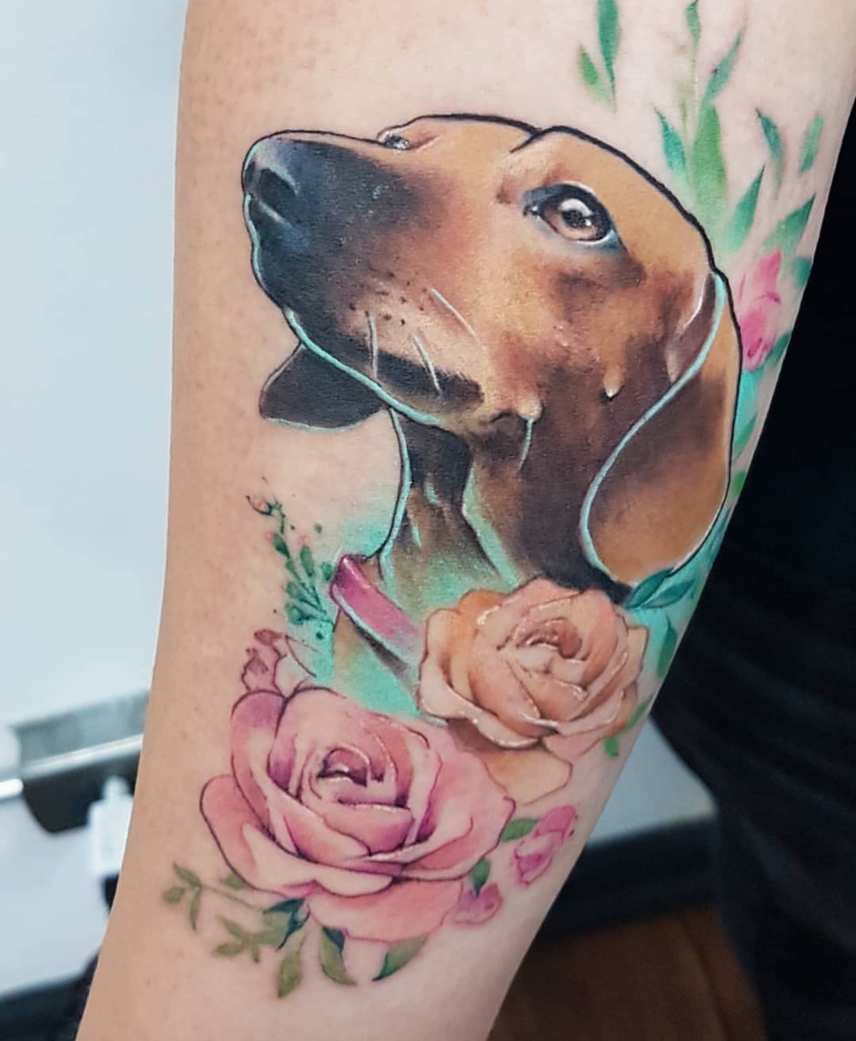 brown Dachshund with flowers tattoo on wrist