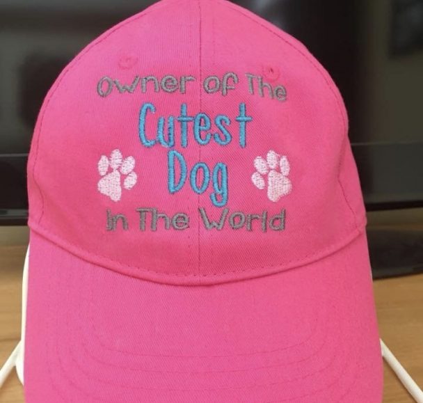 a pink cap with - owner of the cutest dog in the world
