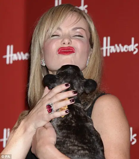 A French Bulldog kissing the chin of a celebrity named Amanda Hodden