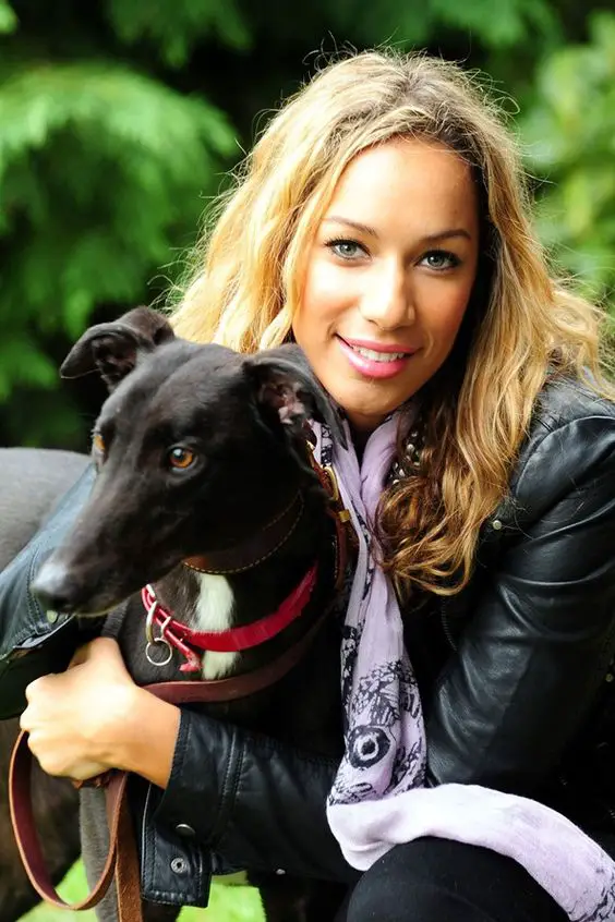 Leona Lewis sitting on the couch with her Greyhound beside her