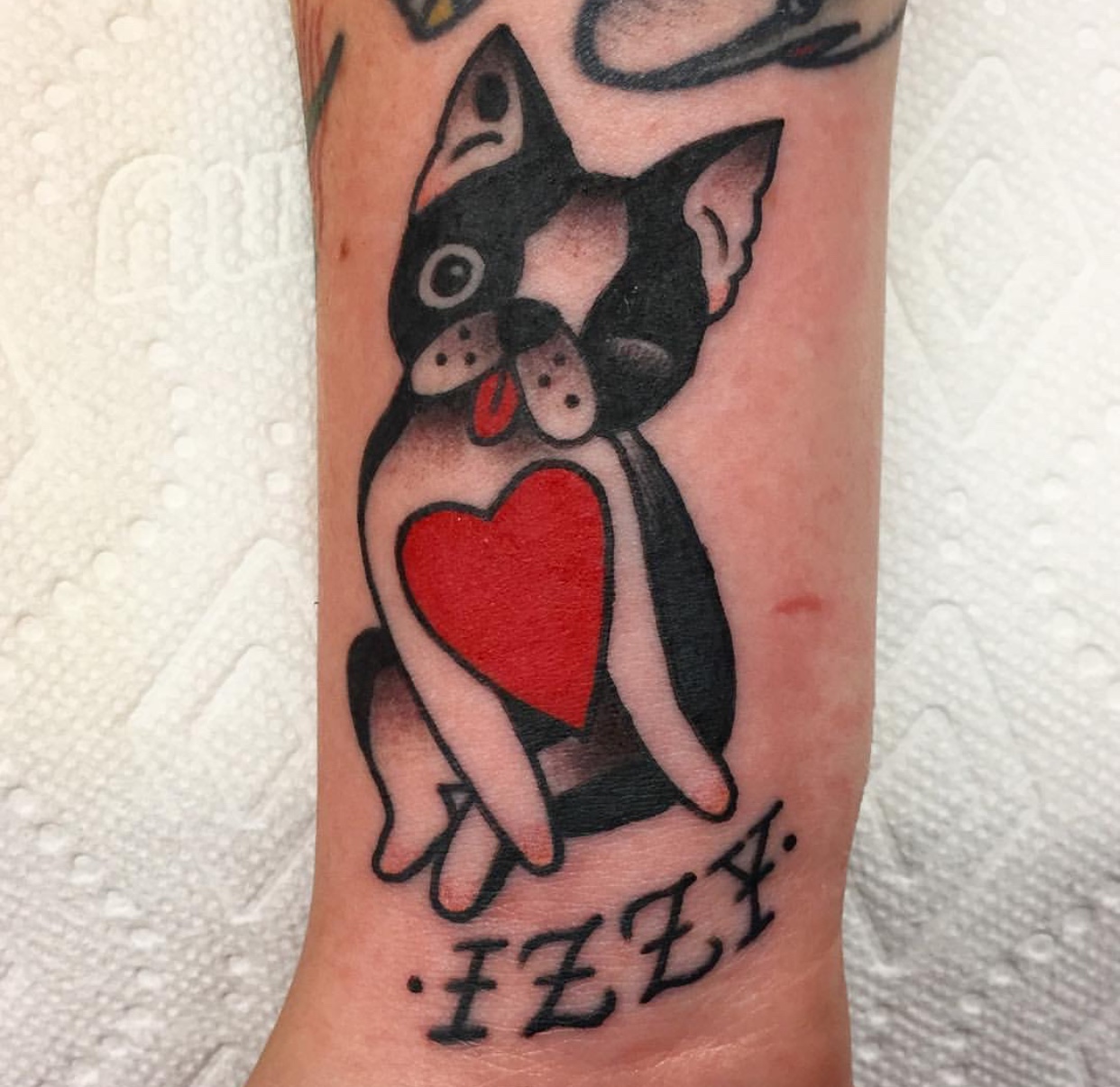animated winking Boston Terrier with a red heart in its chest tattoo