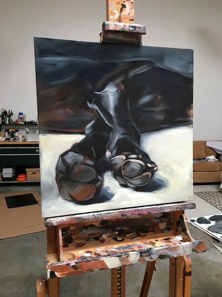 feet of the black Labrador Retriever painting in the paint stand 