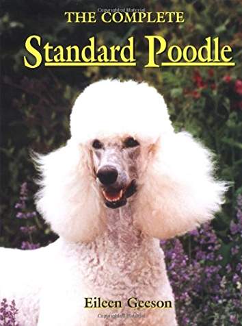 Book cover with title-The Complete Standard Poodle. And a photo of a happy Poodle in the garden