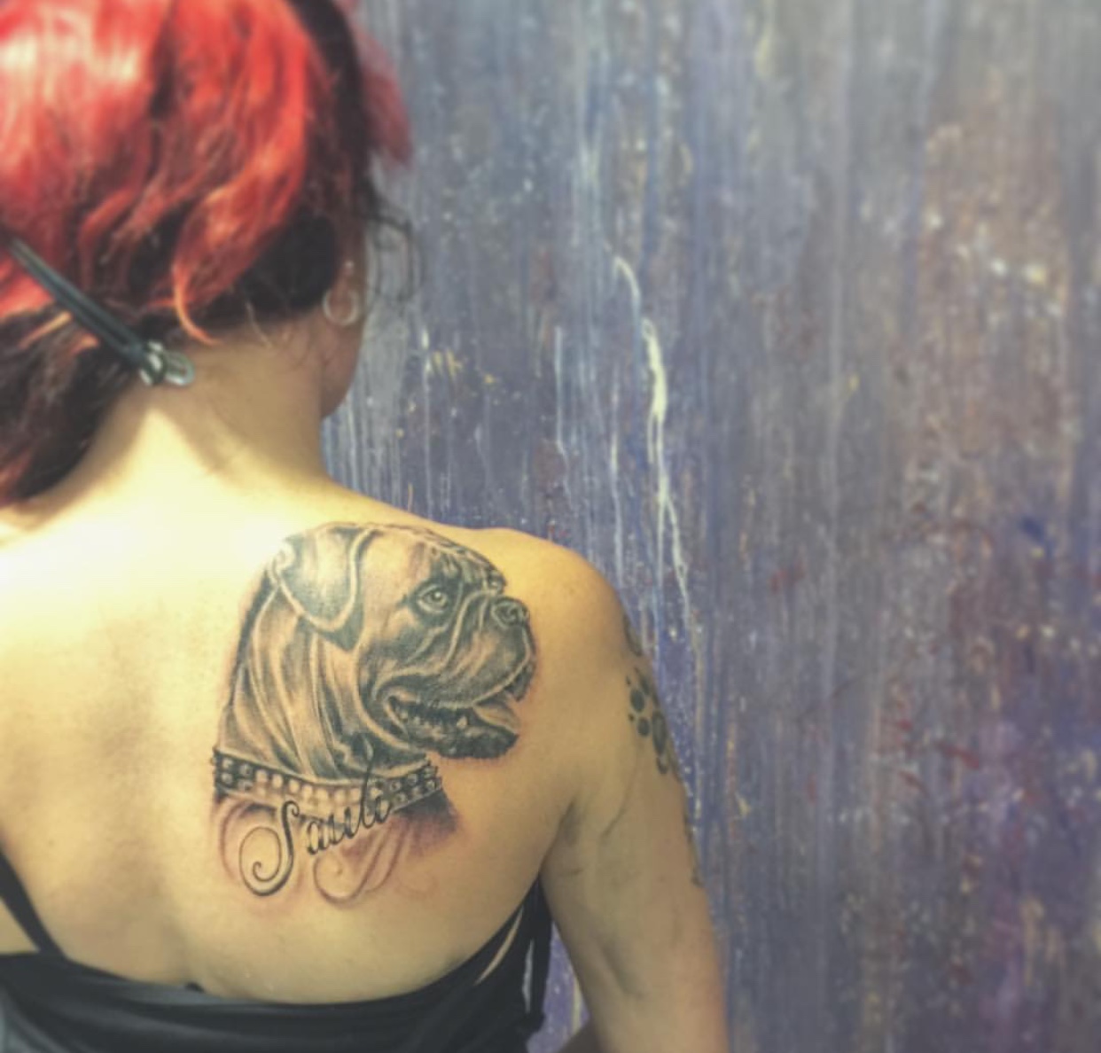 black and gray sideview face of a Boxer tattoo on the back of a woman
