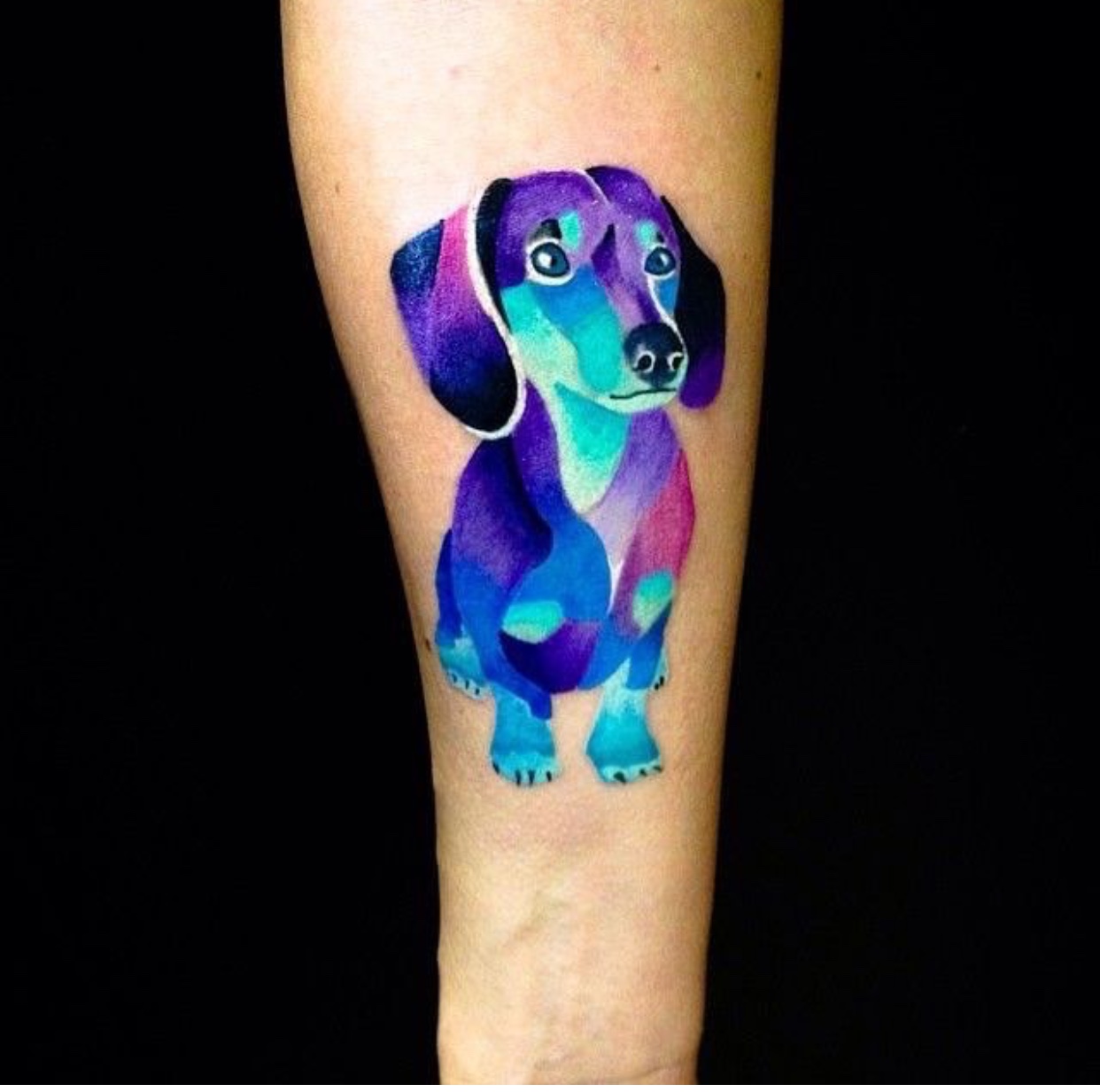  iridescent colored Dachshund tattoo on arm