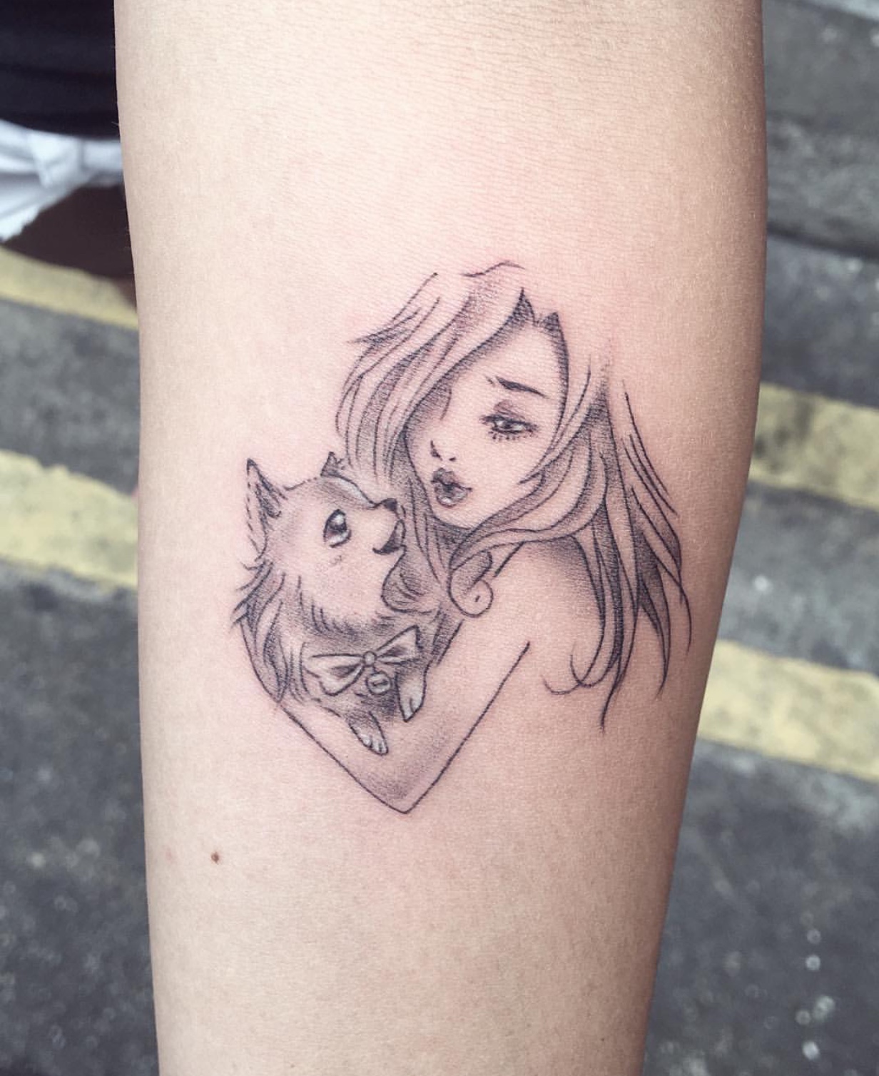 Chihuahua looking up a girl tattoo on the arm