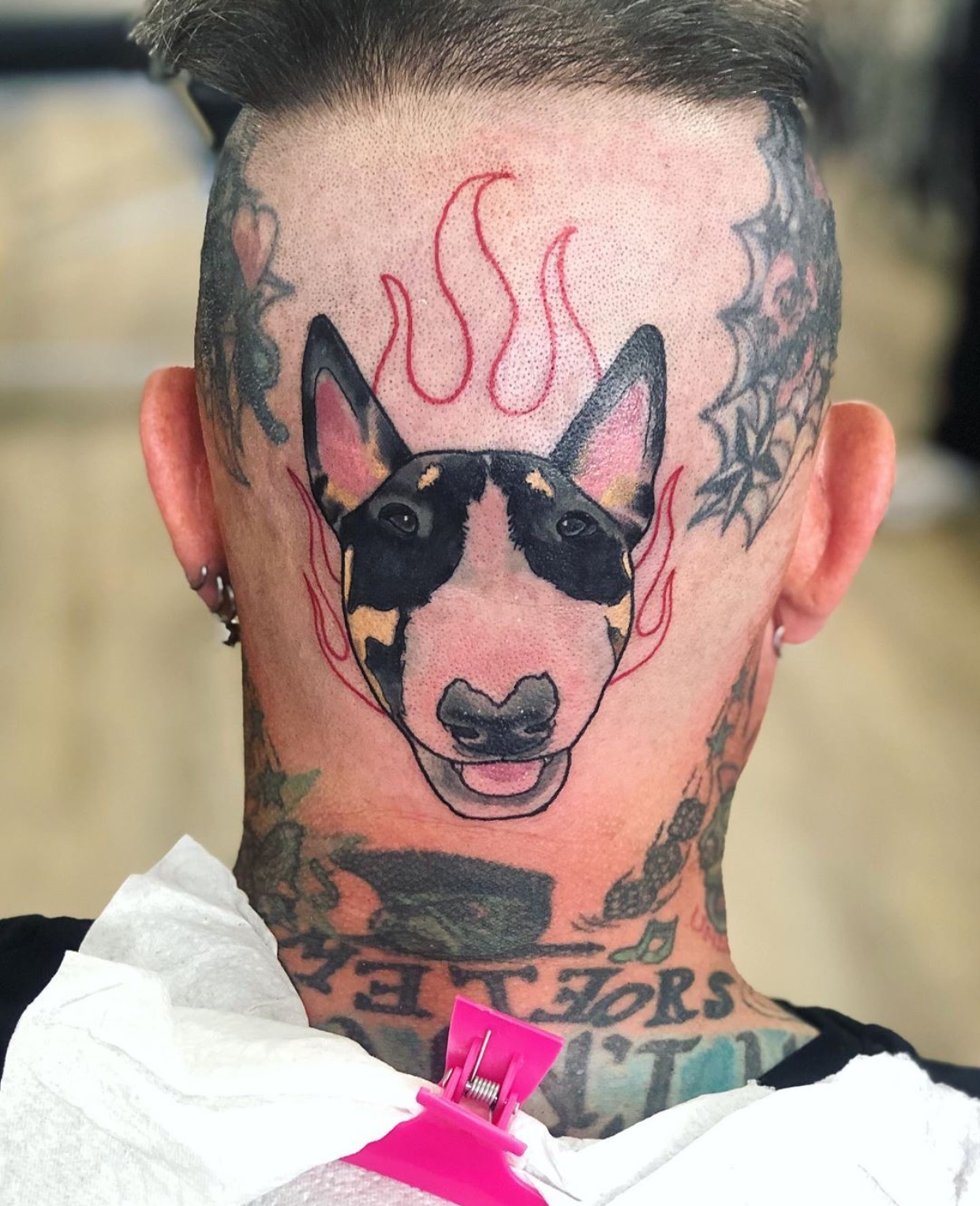 smiling face of Bull Terrier tattoo on the back of the head