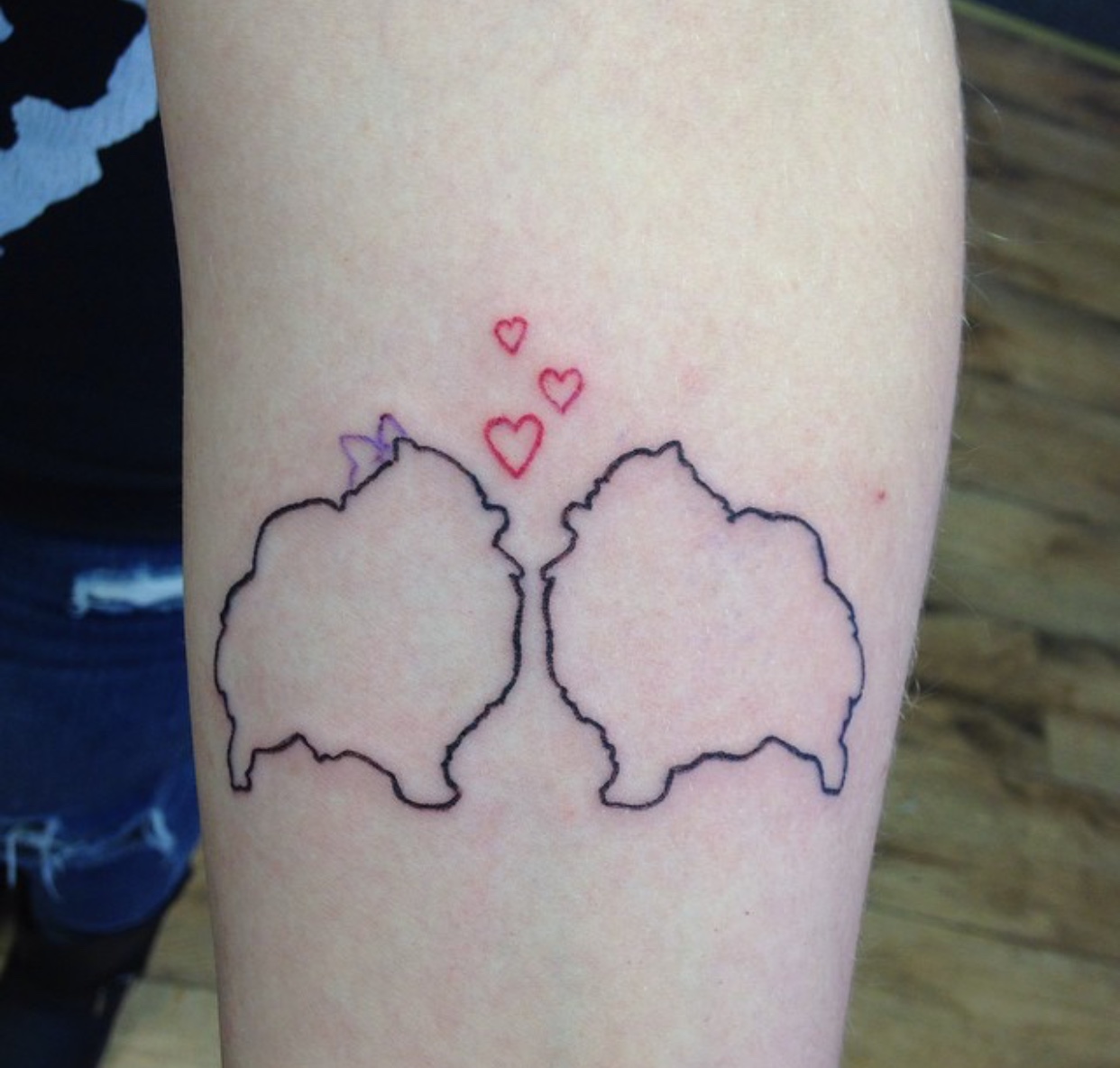 outline of two Pomeranian with red hearts tattoo