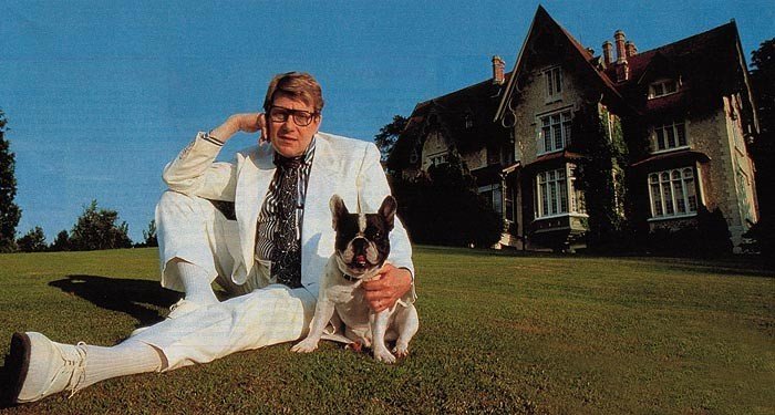Yves Henri Donat Mathieu-Saint-Laurent sitting in the yard with his French Bulldog sitting beside him