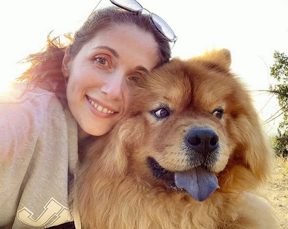 A woman taking a selfie with her Chow Chow