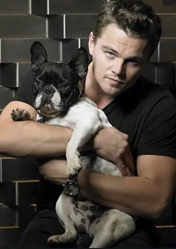 Leonardo diCaprio holding his French Bulldog