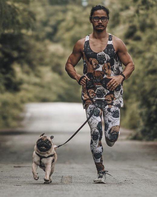 Pug running with its owner