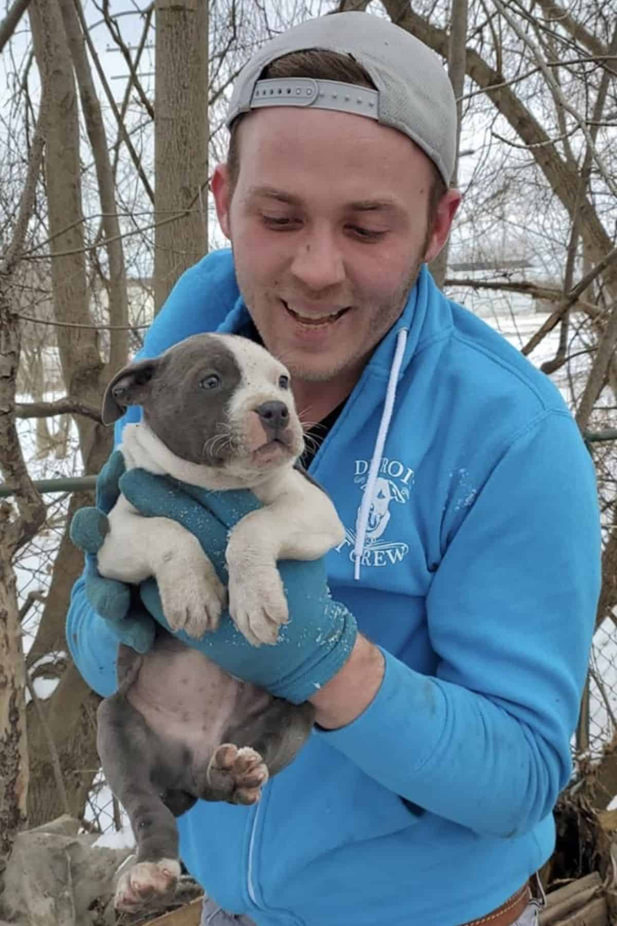 Man holding pit bull puppy